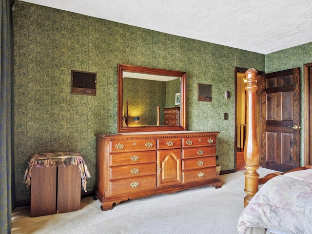 bedroom featuring a textured ceiling and light carpet