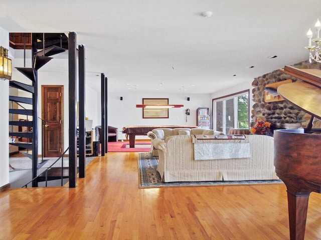 living room with pool table and light hardwood / wood-style flooring