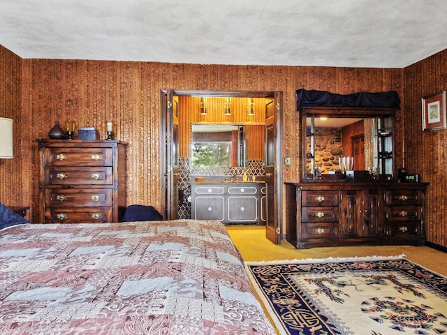 bedroom featuring wood walls and a textured ceiling