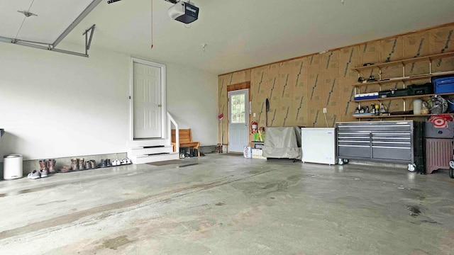 garage with a garage door opener and fridge