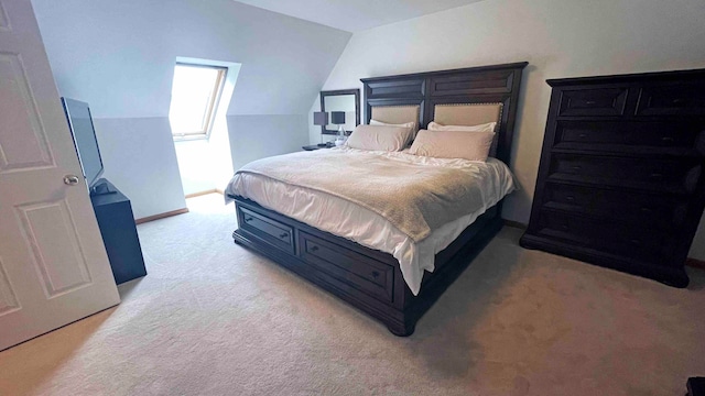 carpeted bedroom featuring lofted ceiling