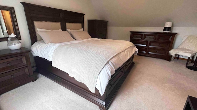 bedroom with vaulted ceiling and carpet flooring