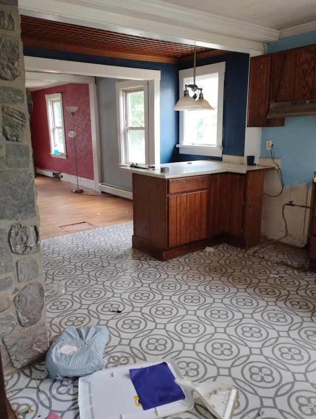 kitchen featuring a healthy amount of sunlight, pendant lighting, a baseboard heating unit, and ornamental molding