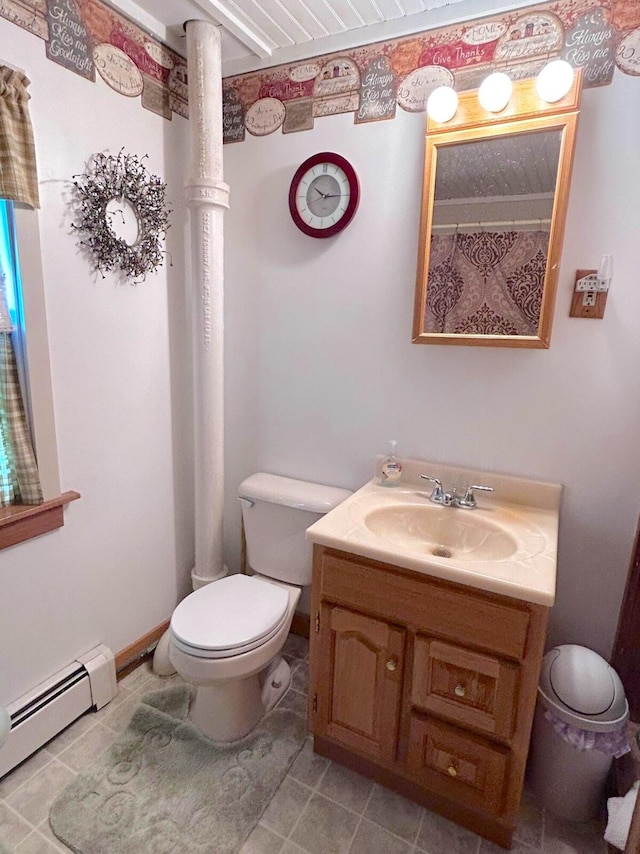 bathroom with tile floors, a baseboard radiator, toilet, and large vanity