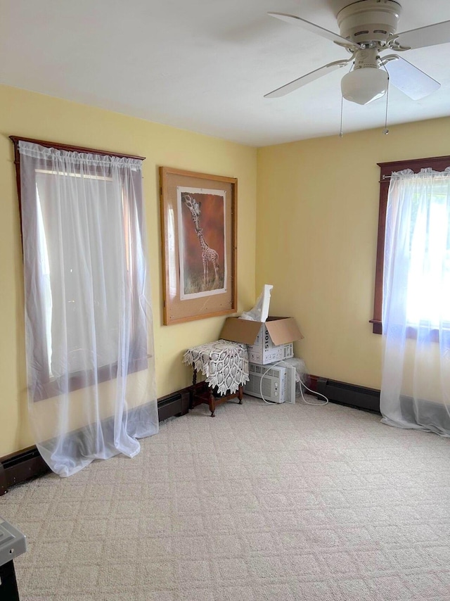 sitting room featuring ceiling fan, a baseboard heating unit, and carpet flooring