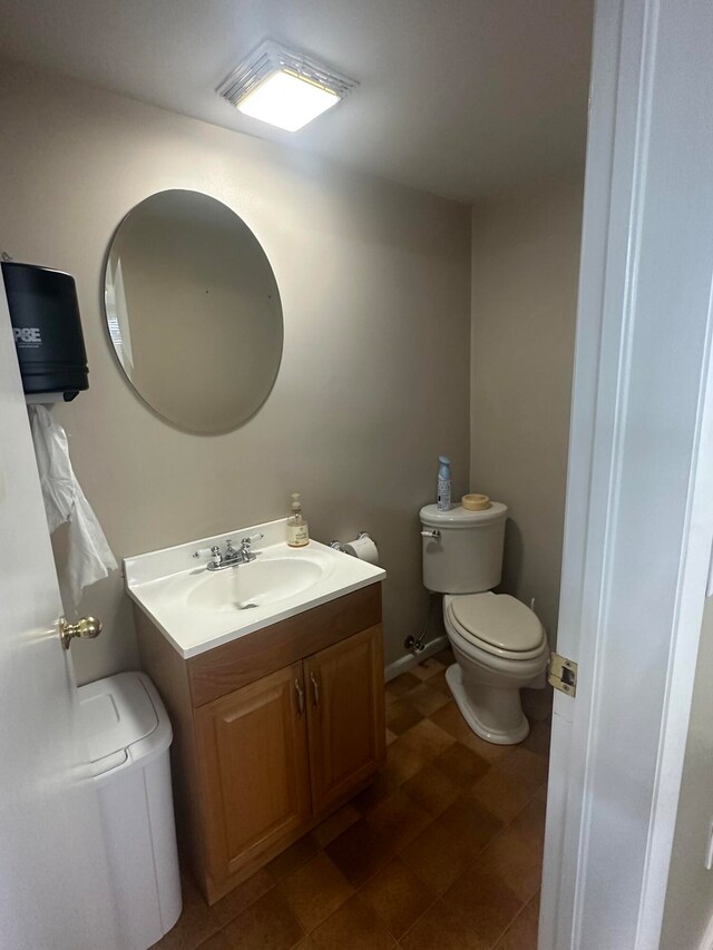 bathroom with vanity, tile floors, and toilet