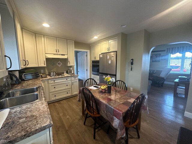 kitchen featuring dark hardwood / wood-style floors, sink, stainless steel appliances, and white cabinetry