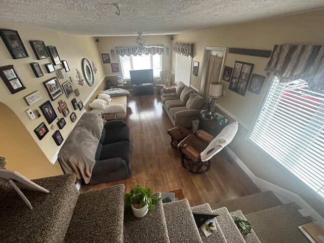 living room featuring wood-type flooring and a textured ceiling