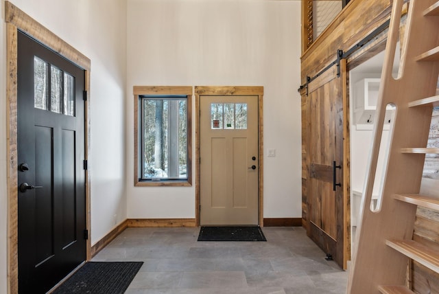 foyer featuring a barn door and a towering ceiling