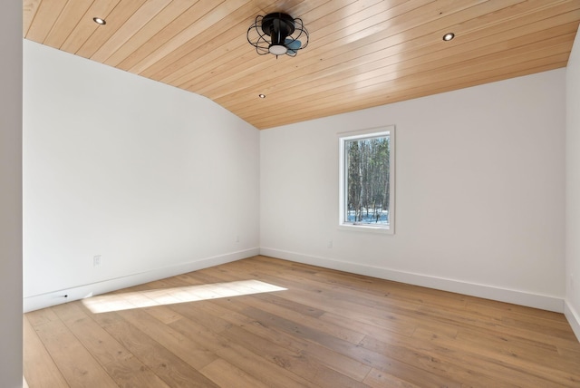 spare room with lofted ceiling, wooden ceiling, and light hardwood / wood-style floors