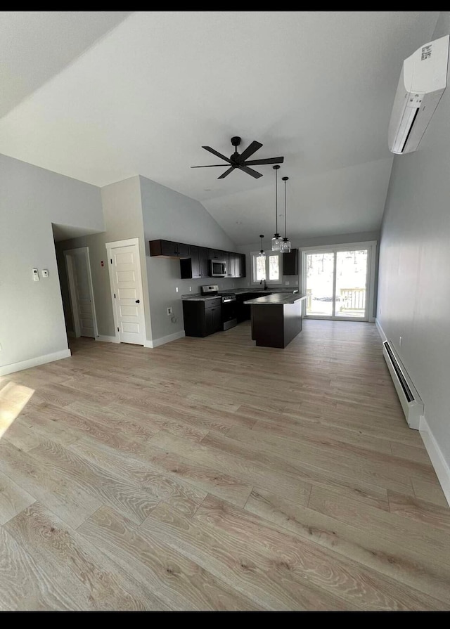 living room featuring a baseboard heating unit, lofted ceiling, light hardwood / wood-style flooring, and a wall mounted AC