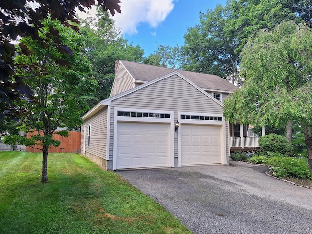 view of side of property featuring a lawn and a garage