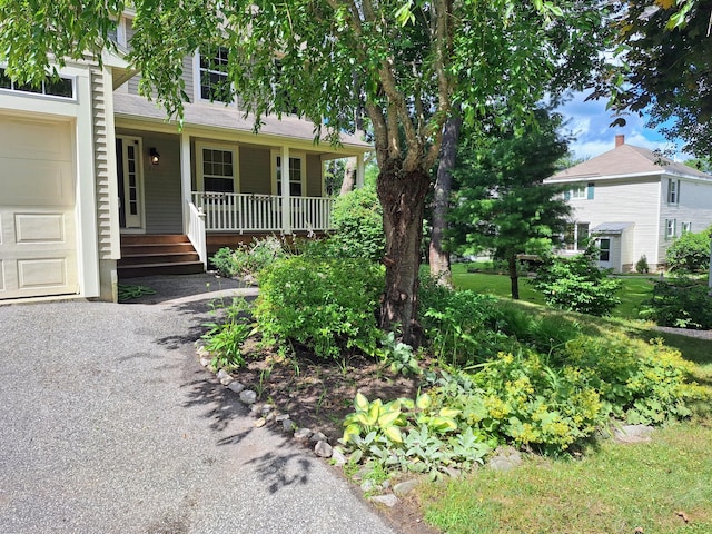 view of front facade featuring a porch and a garage