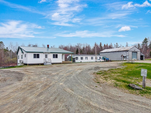 view of front facade with a garage and an outdoor structure