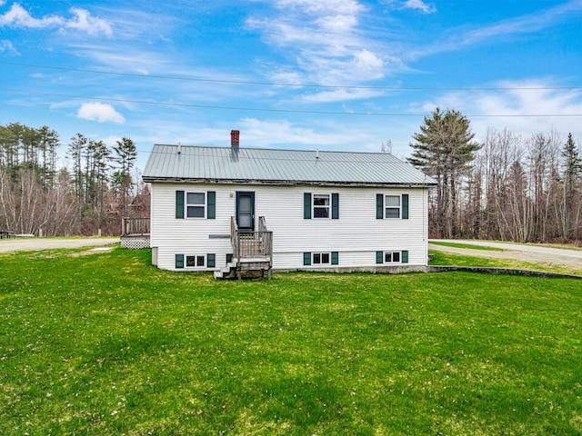 back of house with a lawn