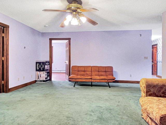 sitting room with a baseboard heating unit, a textured ceiling, ceiling fan, and carpet floors