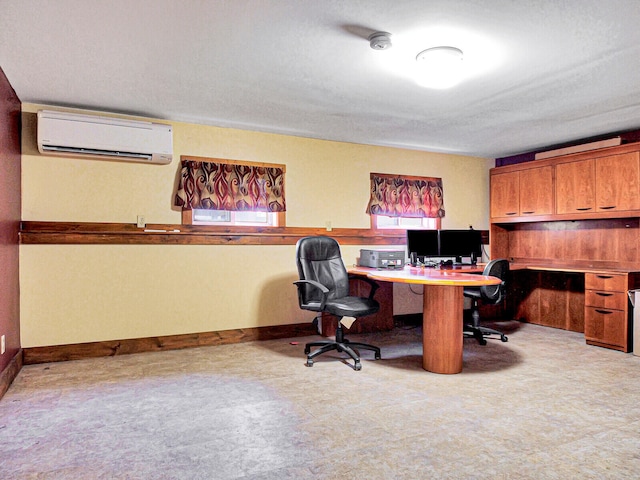 office area with plenty of natural light, built in desk, a textured ceiling, and a wall mounted AC