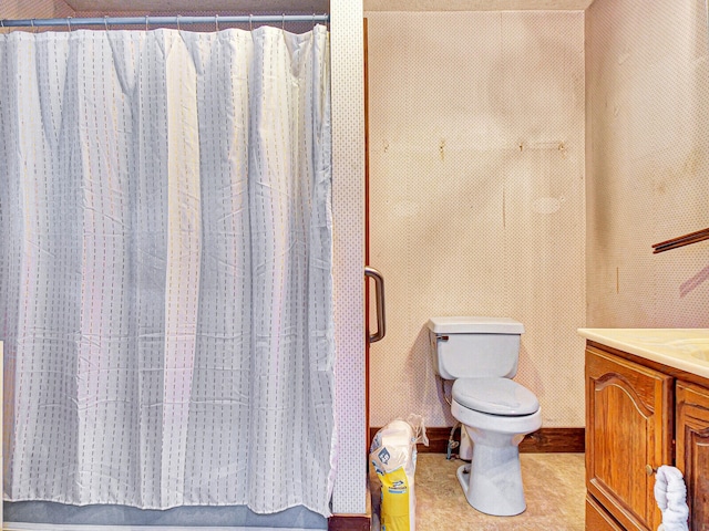 bathroom with toilet, tile flooring, and vanity