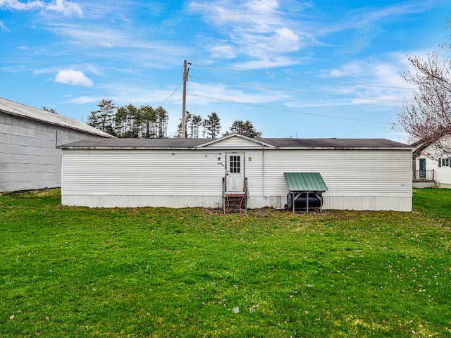 back of property featuring a lawn