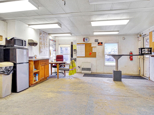 garage with stainless steel refrigerator