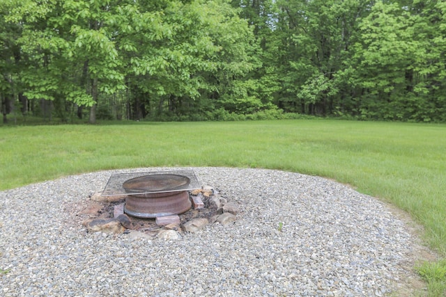 view of yard featuring an outdoor fire pit