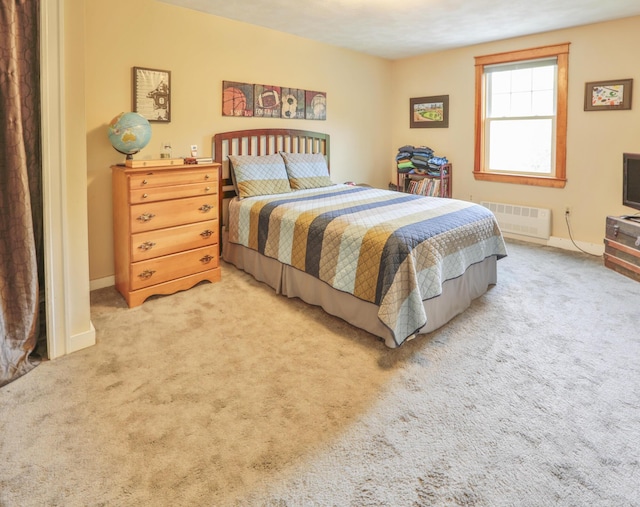 carpeted bedroom featuring radiator