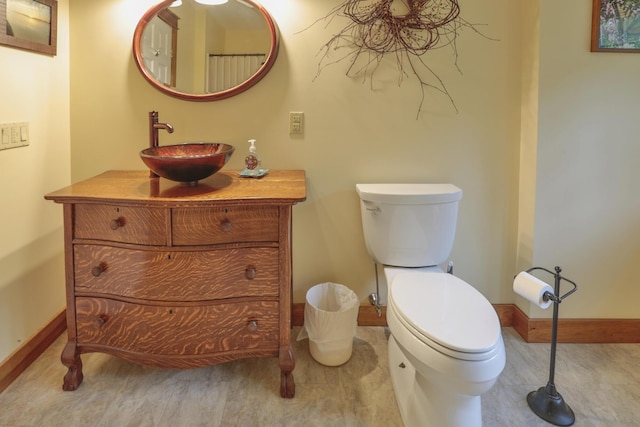 bathroom featuring wood-type flooring, vanity, and toilet