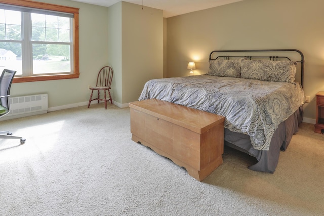 carpeted bedroom with radiator heating unit