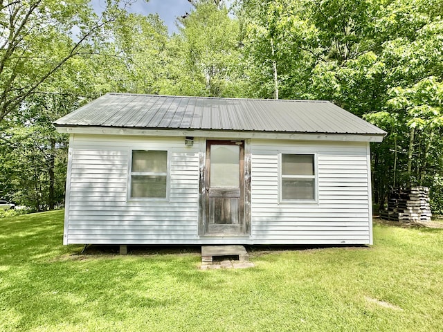 view of outbuilding featuring a lawn