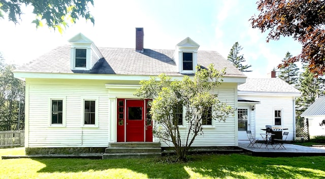 rear view of house with a lawn