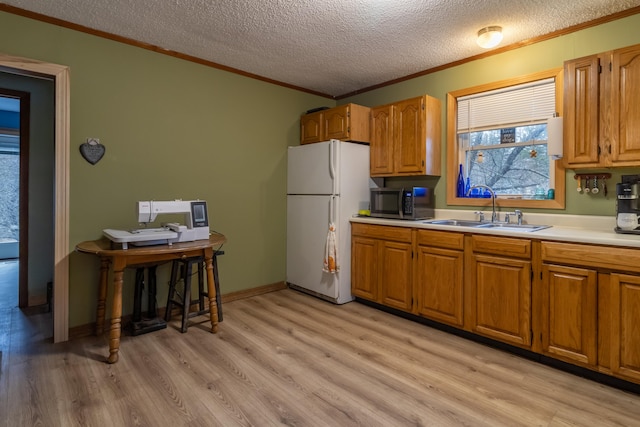 98 Old Rte 1, Gouldsboro, ME 04607 - kitchen featuring sink, light wood-type flooring, white fridge, and a textured ceiling