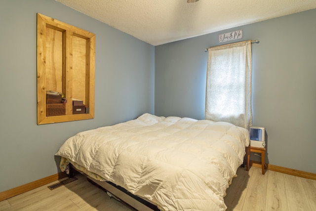 98 Old Rte 1, Gouldsboro, ME 04607 - bedroom with a textured ceiling and light hardwood / wood-style floors