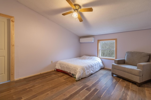 98 Old Rte 1, Gouldsboro, ME 04607 - bedroom with ceiling fan, a wall mounted air conditioner, a textured ceiling, vaulted ceiling, and hardwood / wood-style flooring