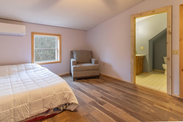 98 Old Rte 1, Gouldsboro, ME 04607 - bedroom with ensuite bath, tile flooring, a wall mounted air conditioner, and lofted ceiling