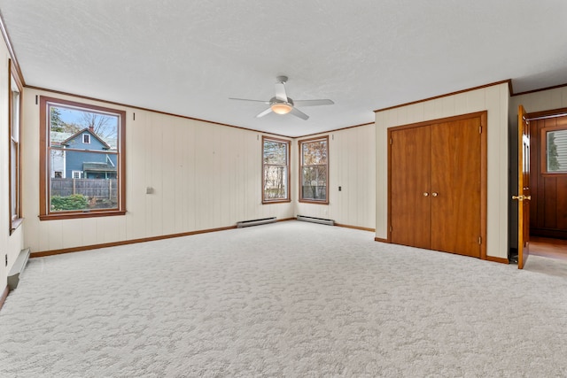 unfurnished bedroom with ornamental molding, carpet flooring, ceiling fan, and a textured ceiling