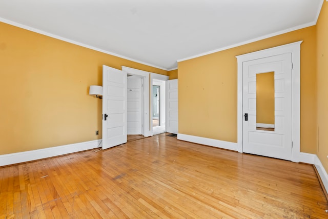 unfurnished room featuring light hardwood / wood-style flooring and ornamental molding