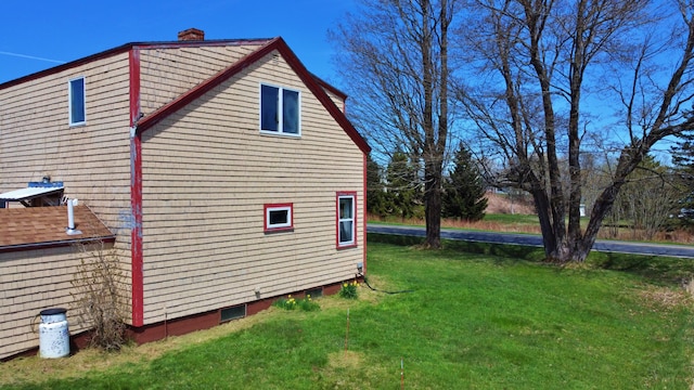 view of side of property with a lawn