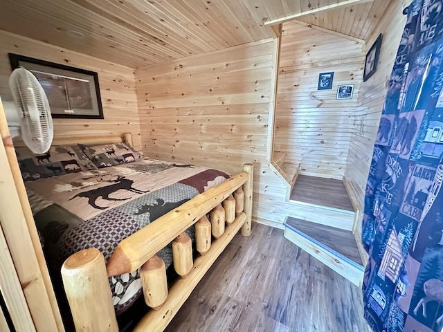 bedroom featuring wood-type flooring, wood walls, and wood ceiling