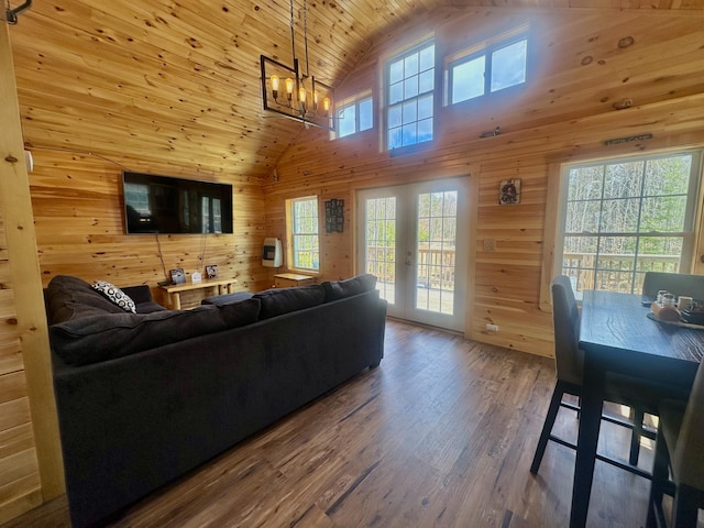 living room featuring hardwood / wood-style flooring, wood ceiling, wooden walls, and high vaulted ceiling