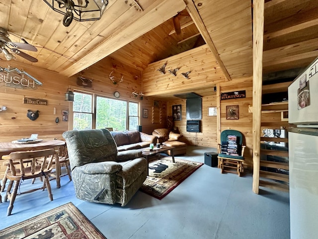 living room with beamed ceiling, ceiling fan, wooden walls, and wood ceiling