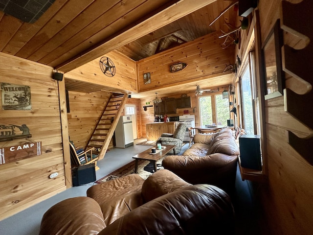 living room with wooden ceiling, beam ceiling, ceiling fan, and wooden walls