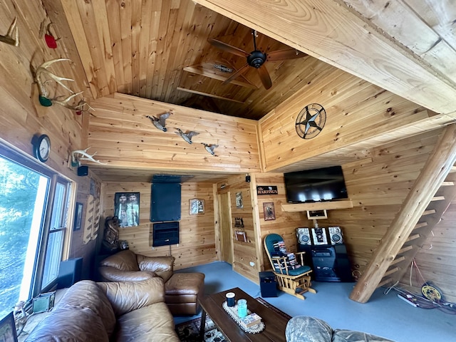 living room with wood walls, ceiling fan, and wood ceiling