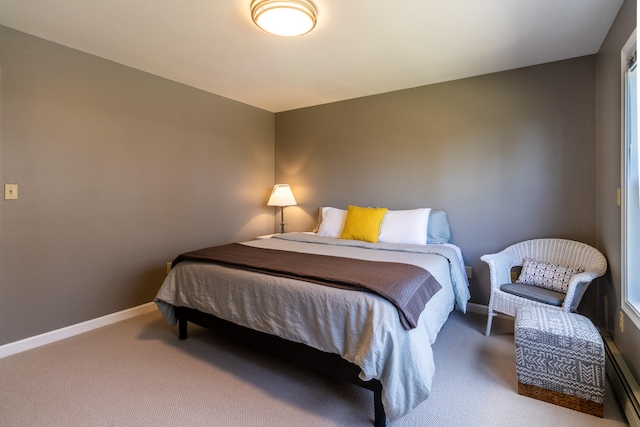 carpeted bedroom featuring baseboard heating