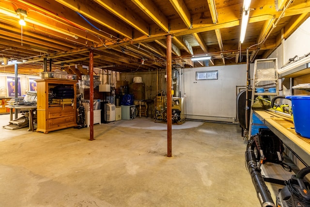 basement with a workshop area and a baseboard heating unit