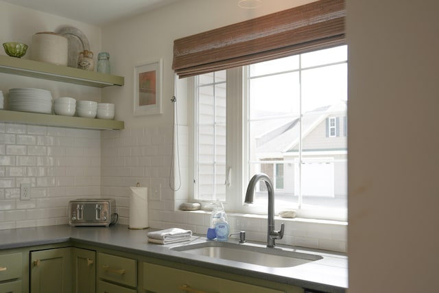 kitchen with backsplash, plenty of natural light, and sink