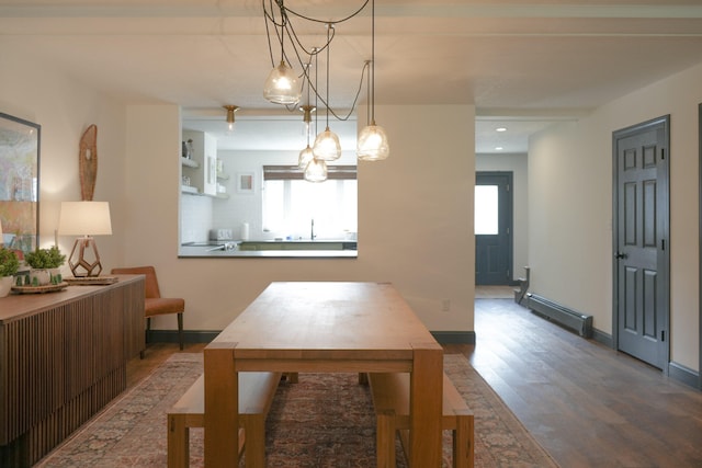 dining room with plenty of natural light, sink, dark hardwood / wood-style flooring, and a baseboard heating unit