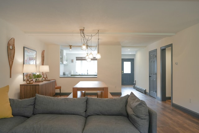 living room with wood-type flooring, an inviting chandelier, and baseboard heating