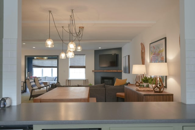 carpeted living room with a chandelier