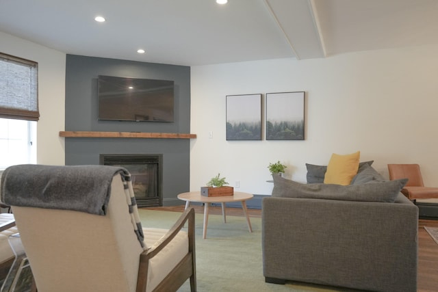 living room with hardwood / wood-style floors and beam ceiling