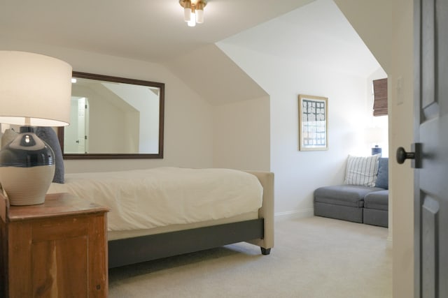 bedroom with lofted ceiling and carpet flooring